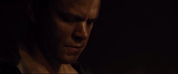 Movie still from “Jason Bourne” (2016), directed by Paul Greengrass – A man's face in the dark; Close Up shot, Low angle