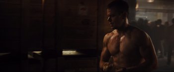 Movie still from “Jason Bourne” (2016), directed by Paul Greengrass – A shirtless man with blood on his chest; Medium shot, Low angle