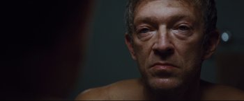 Movie still from “Jason Bourne” (2016), directed by Paul Greengrass – A man's face in a dark room; Close Up shot, High angle