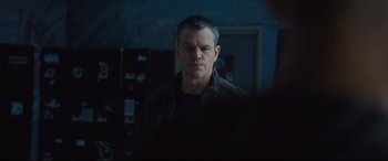 Movie still from “Jason Bourne” (2016), directed by Paul Greengrass – A person wearing a jacket; Close Up shot, Over the shoulder angle