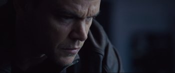 Movie still from “Jason Bourne” (2016), directed by Paul Greengrass – A man's face in a black jacket; Close Up shot, Low angle