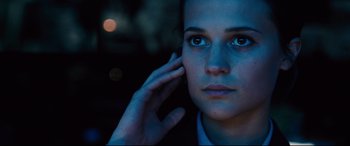 Movie still from “Jason Bourne” (2016), directed by Paul Greengrass – A person holding their hand up to their ear; Close Up shot, Low angle