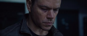 Movie still from “Jason Bourne” (2016), directed by Paul Greengrass – A person wearing a black jacket; Close Up shot, Low angle