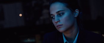 Movie still from “Jason Bourne” (2016), directed by Paul Greengrass – A person wearing a suit and looking sad; Close Up shot, Over the shoulder angle