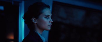 Movie still from “Jason Bourne” (2016), directed by Paul Greengrass – A woman in a suit looking to her left; Close Up shot, Low angle