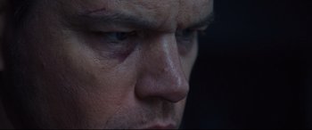 Movie still from “Jason Bourne” (2016), directed by Paul Greengrass – A man's face with a bruise on his face; Extreme Close Up shot, Low angle