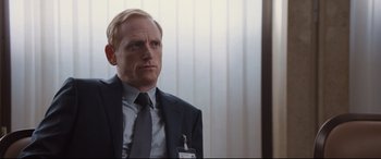 Movie still from “Jason Bourne” (2016), directed by Paul Greengrass – A man in a suit and tie; Close Up shot, Over the shoulder angle