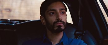 Movie still from “Jason Bourne” (2016), directed by Paul Greengrass – A person sitting in a car looking at the camera; Close Up shot, Over the shoulder angle