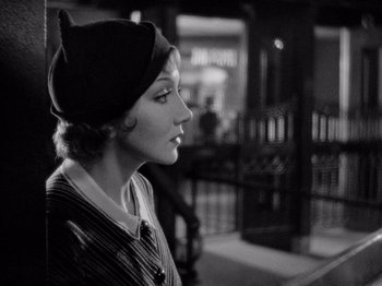 Movie still from “It Happened One Night” (1934), directed by Frank Capra – An old photo of a woman wearing a hat; Close Up shot, Over the shoulder angle
