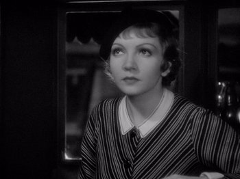 Movie still from “It Happened One Night” (1934), directed by Frank Capra – An old photo of a woman in a striped shirt; Close Up shot, Low angle