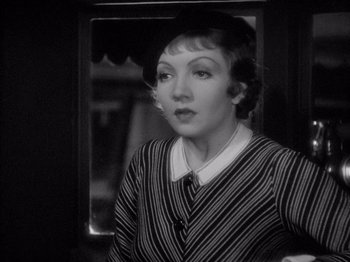 Movie still from “It Happened One Night” (1934), directed by Frank Capra – An old photo of a woman looking at the camera; Close Up shot, Over the shoulder angle