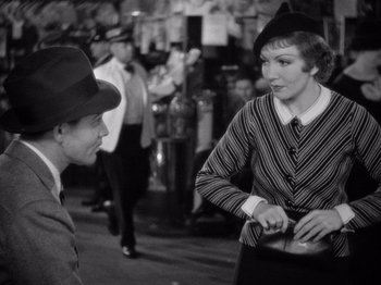 Movie still from “It Happened One Night” (1934), directed by Frank Capra – An old photo of a man and a woman talking to each other; Medium shot, Over the shoulder angle