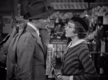 Movie still from “It Happened One Night” (1934), directed by Frank Capra – A man and a woman talking to each other; Medium shot, High angle