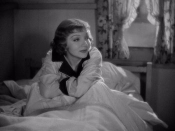 Movie still from “It Happened One Night” (1934), directed by Frank Capra – A woman laying in a bed under a blanket; Medium shot, High angle