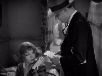 Movie still from “It Happened One Night” (1934), directed by Frank Capra – A man and a woman are looking at a piece of paper; Medium shot, Over the shoulder angle