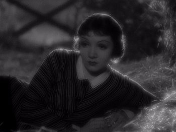 Movie still from “It Happened One Night” (1934), directed by Frank Capra – An old photo of a woman in a striped sweater; Close Up shot, High angle