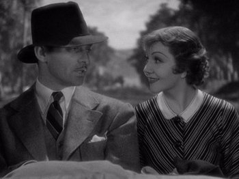 Movie still from “It Happened One Night” (1934), directed by Frank Capra – A man and a woman sitting next to each other; Close Up shot, High angle