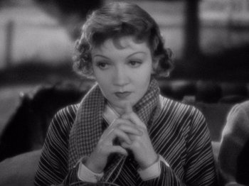 Movie still from “It Happened One Night” (1934), directed by Frank Capra – An old photo of a woman with a scarf around her neck; Close Up shot, High angle