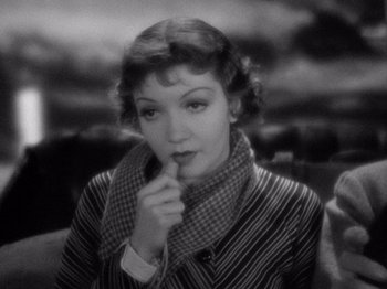 Movie still from “It Happened One Night” (1934), directed by Frank Capra – An old photo of a woman with a scarf around her neck; Close Up shot, High angle