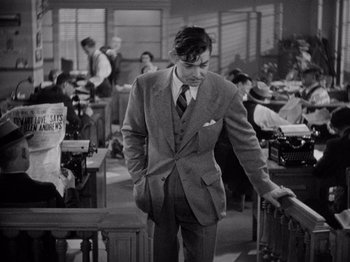 Movie still from “It Happened One Night” (1934), directed by Frank Capra – A black and white photo of a man in a suit and tie; Medium shot, High angle