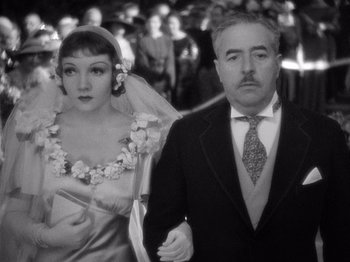Movie still from “It Happened One Night” (1934), directed by Frank Capra – A man and a woman walking down the aisle of a wedding; Close Up shot, Low angle