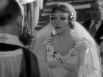 Movie still from “It Happened One Night” (1934), directed by Frank Capra – A black and white photo of a woman in a wedding dress; Close Up shot, Over the shoulder angle