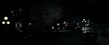 Movie still from “J. Edgar” (2011), directed by Clint Eastwood – A tree in the middle of a dark street at night; Extreme Wide shot, High angle