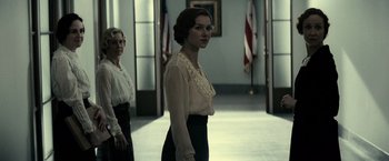 Movie still from “J. Edgar” (2011), directed by Clint Eastwood – A woman in a white blouse and black skirt; Medium shot, Low angle