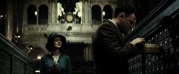 Movie still from “J. Edgar” (2011), directed by Clint Eastwood – A man and a woman standing next to each other in front of a clock tower; Medium shot, Low angle