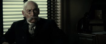 Movie still from “J. Edgar” (2011), directed by Clint Eastwood – An old man with a mustache wearing a suit and tie; Close Up shot, Low angle