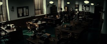 Movie still from “J. Edgar” (2011), directed by Clint Eastwood – Three men are sitting in an old fashioned office; Extreme Wide shot, High angle