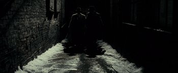 Movie still from “J. Edgar” (2011), directed by Clint Eastwood – A couple of men walking down a dark alley way; Wide shot, High angle