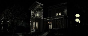 Movie still from “J. Edgar” (2011), directed by Clint Eastwood – A house that is lit up at night time; Wide shot, Low angle