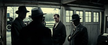 Movie still from “J. Edgar” (2011), directed by Clint Eastwood – A group of men standing next to each other in front of a window; Medium shot, Low angle