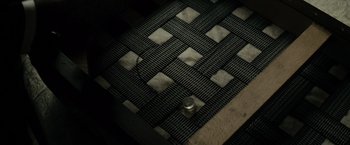 Movie still from “J. Edgar” (2011), directed by Clint Eastwood – A metal can sitting on top of a metal floor; Extreme Close Up shot, Overhead angle