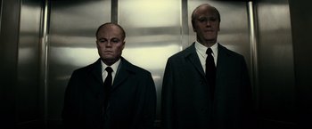 Movie still from “J. Edgar” (2011), directed by Clint Eastwood – Two men in suits and ties standing next to each other; Medium shot, Low angle