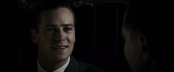 Movie still from “J. Edgar” (2011), directed by Clint Eastwood – A person wearing a suit and tie; Close Up shot, Over the shoulder angle