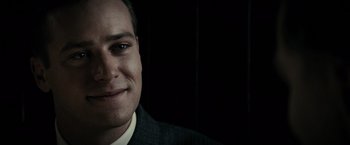 Movie still from “J. Edgar” (2011), directed by Clint Eastwood – A person wearing a suit and tie; Close Up shot, Over the shoulder angle