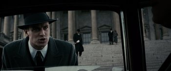 Movie still from “J. Edgar” (2011), directed by Clint Eastwood – A group of people walking down the steps of a building; Close Up shot, Over the shoulder angle