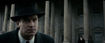 Movie still from “J. Edgar” (2011), directed by Clint Eastwood – A man wearing a hat and a suit; Close Up shot, Low angle