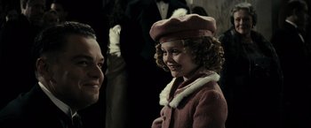Movie still from “J. Edgar” (2011), directed by Clint Eastwood – A little girl wearing a pink coat and a hat; Close Up shot, Over the shoulder angle