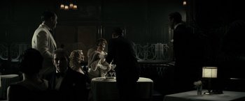 Movie still from “J. Edgar” (2011), directed by Clint Eastwood – A group of people sitting at a table in a room; Wide shot, Over the shoulder angle