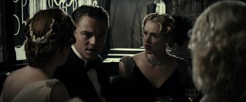 Movie still from “J. Edgar” (2011), directed by Clint Eastwood – A man and a woman in formal wear looking at each other; Medium shot, Over the shoulder angle