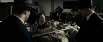 Movie still from “J. Edgar” (2011), directed by Clint Eastwood – A group of people sitting at a table with food; Medium shot, Over the shoulder angle