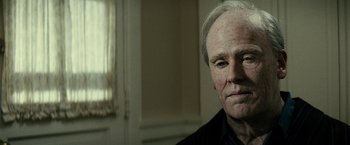 Movie still from “J. Edgar” (2011), directed by Clint Eastwood – An old man with a gray hair and a black shirt; Close Up shot, Over the shoulder angle