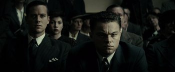 Movie still from “J. Edgar” (2011), directed by Clint Eastwood – A group of men and women in suits and ties; Close Up shot, Over the shoulder angle