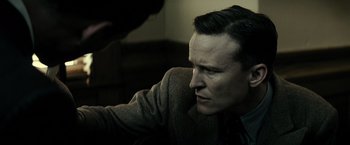 Movie still from “J. Edgar” (2011), directed by Clint Eastwood – A person sitting down with his hand on his shoulder; Close Up shot, Over the shoulder angle