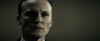 Movie still from “J. Edgar” (2011), directed by Clint Eastwood – A person wearing a suit and tie; Close Up shot, Low angle