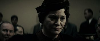 Movie still from “J. Edgar” (2011), directed by Clint Eastwood – A woman in a hat and a suit; Close Up shot, Low angle