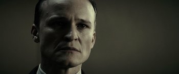 Movie still from “J. Edgar” (2011), directed by Clint Eastwood – A person wearing a suit and tie; Close Up shot, Low angle